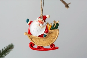 Close-up of Santa Claus on a sleigh resin ornament with gift boxes for Christmas decor