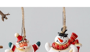 Close-up of resin Santa and Snowman Christmas ornaments with rustic hemp rope hanging loops