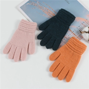 Detailed view of colorful knit gloves for kids in pink, dark blue, and vibrant orange
