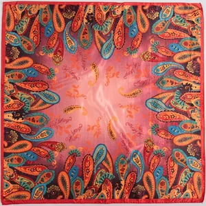 Detail of red paisley square silk scarf featuring intricate chain and floral patterns