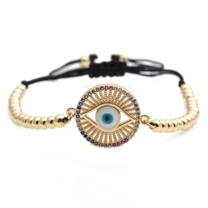 Detail of evil eye bracelet with rainbow zircons and gold beads on adjustable cord