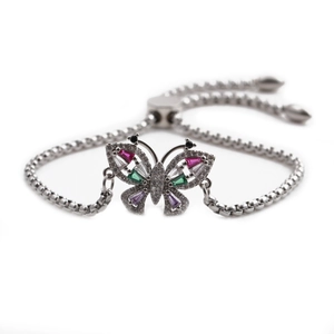 Detailed shot of a silver butterfly bracelet featuring vibrant inlaid colorful gemstones