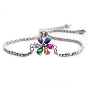 Detail of silver adjustable bracelet featuring colorful teardrop-shaped zircon flower pendant