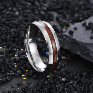 Macro shot of 6mm curved stainless steel ring featuring a dark acacia wood inlay inlay