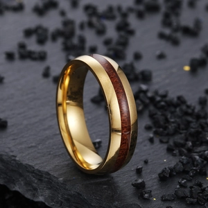 Macro detail of 6mm curved gold stainless steel ring with acacia wood inlay grain