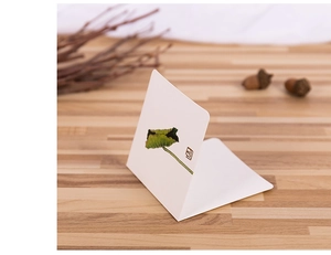 Artistic lotus leaf ink painting on Chinese greeting card with classic red seal stamp