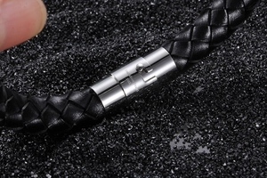 Detailed close-up of 316L stainless steel clasp on braided leather bracelet