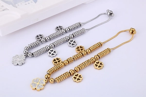 Detail of gold and silver four-leaf clover bracelets with shimmering crystals