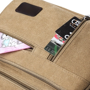 Durable khaki canvas crossbody bag featuring multi-zipper pockets and leather logo detail