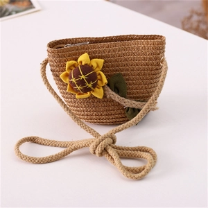 Detailed close-up of handmade straw crossbody bag with decorative 3D sunflower accent
