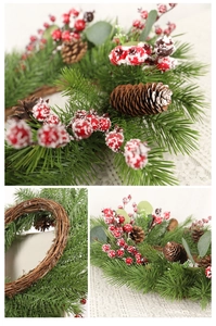 Detail of a 50cm Christmas wreath with red berries, pine cones and rustic rattan base