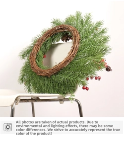 Close-up of artificial pine needles, natural pine cones and red berries on a Christmas wreath