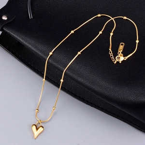 18K gold plated heart necklace with snake chain and bead accents on black leather