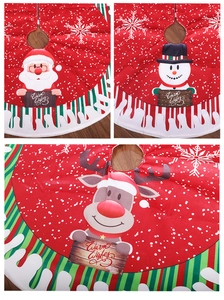 Detail of red Christmas tree skirt featuring cartoon Santa and reindeer character designs