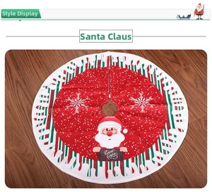 Detail of red Christmas tree skirt featuring Santa Claus and Warm Wishes sign