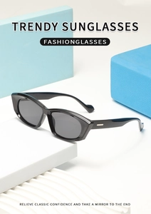 Detail of black cat-eye sunglasses with silver metal temples on a geometric stand