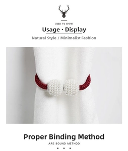 Detail view of pearl curtain tieback with red braided rope and magnetic ball buckle decor