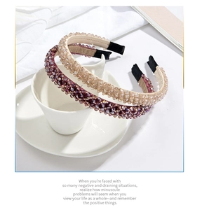 Detail of luxury beaded headbands in champagne and purple over a white coffee cup