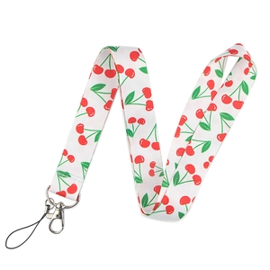 Close-up of white fabric phone lanyard featuring vibrant red cherry and green leaf patterns