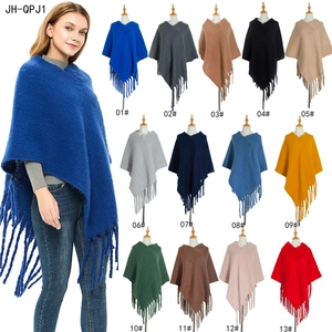 Thick knit poncho wrap with tassels for women, available in 13 vibrant solid colors