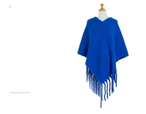 Detailed view of the thick royal blue knit shawl featuring long fringed tassel edges