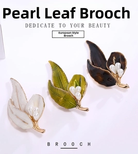 Detail showing leaf-shaped brooches in green, white, and brown with pearl accents
