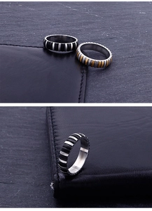 Detail of industrial punk titanium steel rings with textured vertical grooves for men