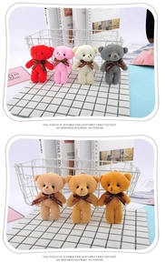 Detail of colorful plush teddy bear keychains with Love ribbons in a decorative basket