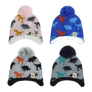 Detail of dinosaur jacquard knit beanies for kids with pom-poms and ear protection