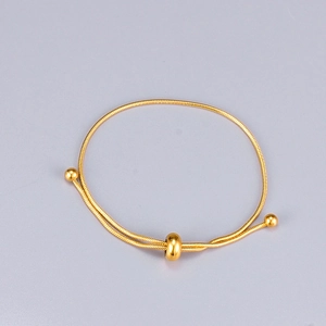 Minimalist adjustable gold snake chain bracelet with sliding toggle and polished beads