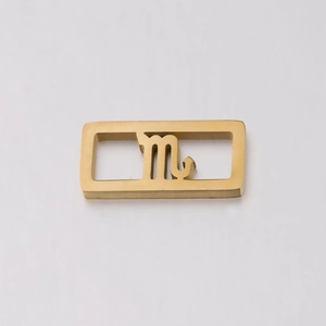Detailed view of a gold Scorpio zodiac charm with hollow rectangular metal design