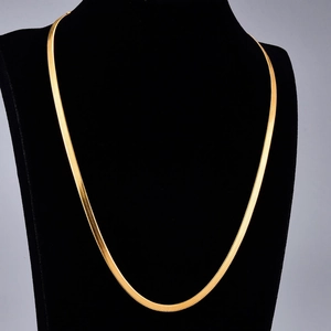 Minimalist gold plated stainless steel snake chain necklace displayed on a black bust