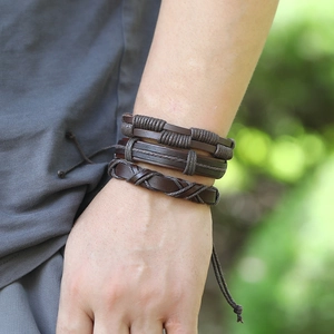 Three-piece set of men's vintage dark brown braided leather bracelets on wrist