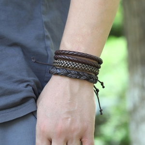 Detail of multi-layer woven leather bracelet set worn on wrist with adjustable drawstrings