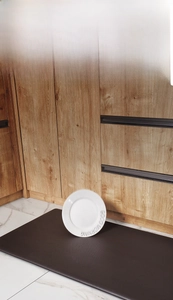 Kitchen PU leather mat showing anti-fall protection with a plate landing on a soft surface