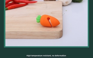 Carrot shaped silicone pot lid lifter for spill prevention on a wooden board