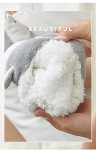 Macro detail of the plush white faux fur lining and soft gray coral fleece on cozy socks