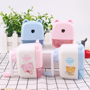 Detail of cute bear-shaped pencil sharpener with hand crank and clear shavings drawer