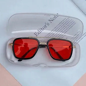 Modern kids sunglasses with red lenses and black-gold frame in clear storage case