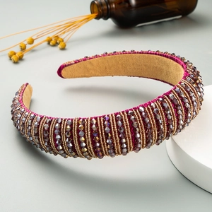 Detail of luxury purple velvet headband with handmade beads and golden accents