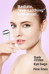 Close-up of alloy eye cream massage roller used on model's skin to reduce dark circles