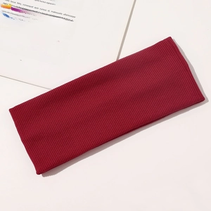 Detailed close-up of dark red ribbed knit yoga headband with high elasticity texture