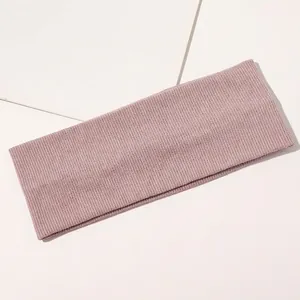 Close-up of pink ribbed knit headband featuring elastic cotton fabric and breathable texture
