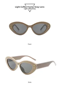 Détail de lunettes de soleil œil-de-chat café clair avec verres gris et étoiles dorées