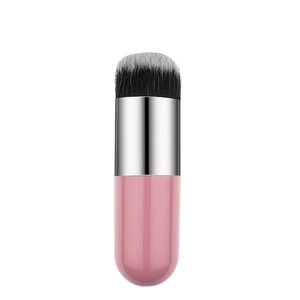 Macro shot of flat-top foundation brush with soft dual-tone bristles and pink capsule handle