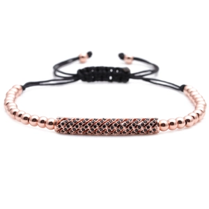 Detail of rose gold beads and micro-set black zircon tube on woven cord bracelet