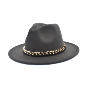 Detail of classic black wool fedora featuring a chunky decorative gold metal chain strap