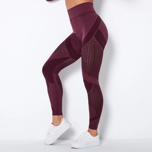 Detail of high-waisted burgundy yoga leggings with geometric cut-out side mesh panels