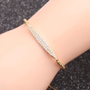 Golden chain bracelet with marquise-shaped micro-pave cubic zirconia on black background