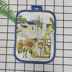 Detailed close-up of a rustic floral oven mat with thick cotton insulation and hanging loop